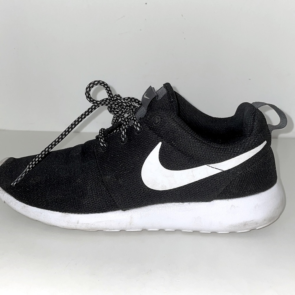 Black and white women Nike running sneakers